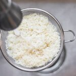 Rinsing white rice in aa sink
