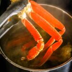 Crab legs being steamed in a pot