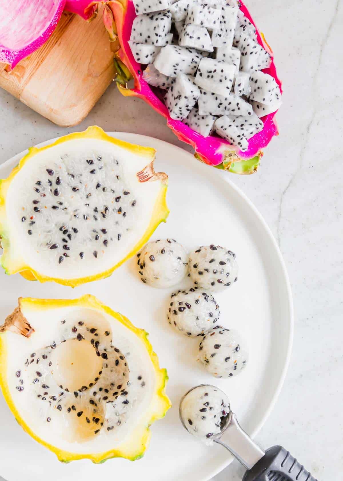 Scooping out balls of dragonfruit using a melon baller