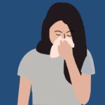 Hydroxyzine: A woman sneezing into a tissue.