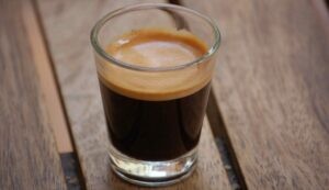 A close-up shot of a freshly brewed espresso with a rich crema
