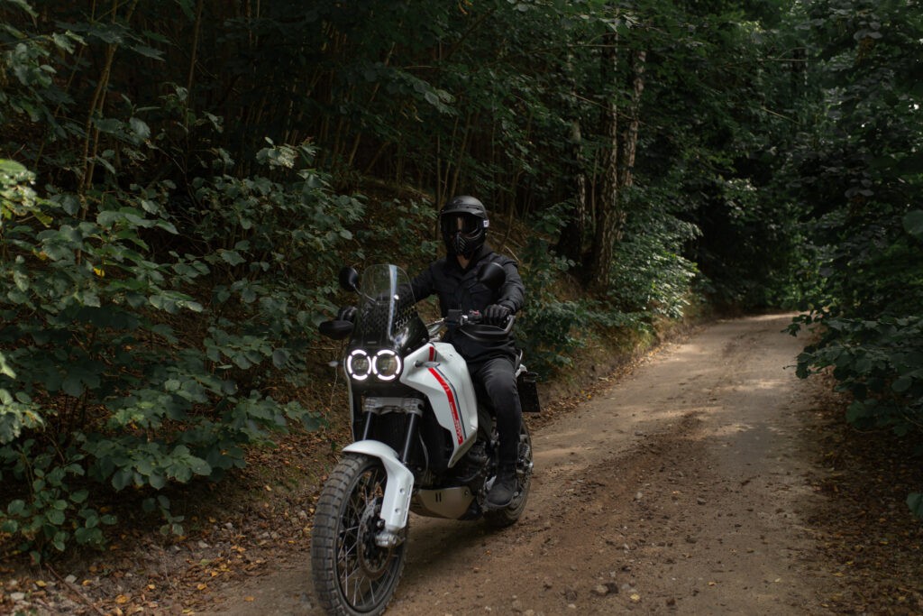 A detailed view of a motorcycle's digital display showing various riding modes and settings, exemplifying advanced technology that increases the price.