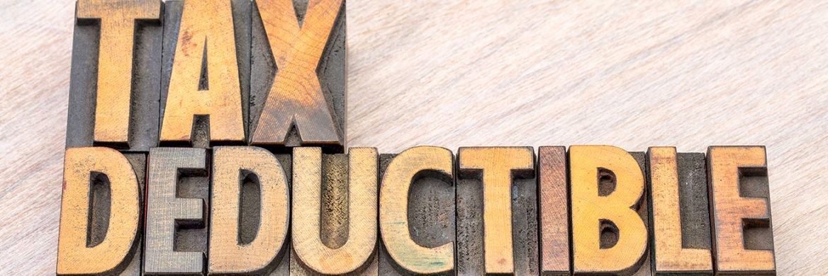 Wooden blocks spell out “Tax Deductible