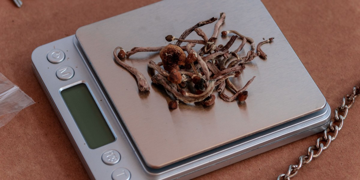 Dried mushrooms on a digital scale with a partial display.