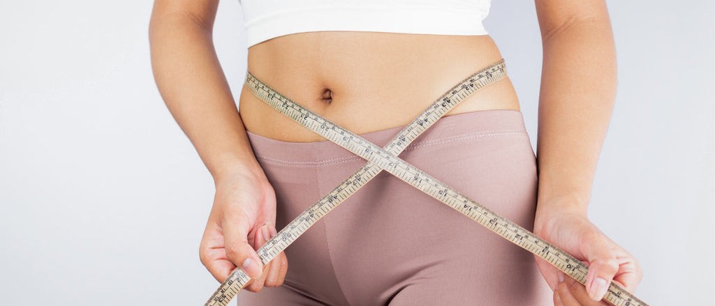 Woman using flexible measuring tape for clothing size