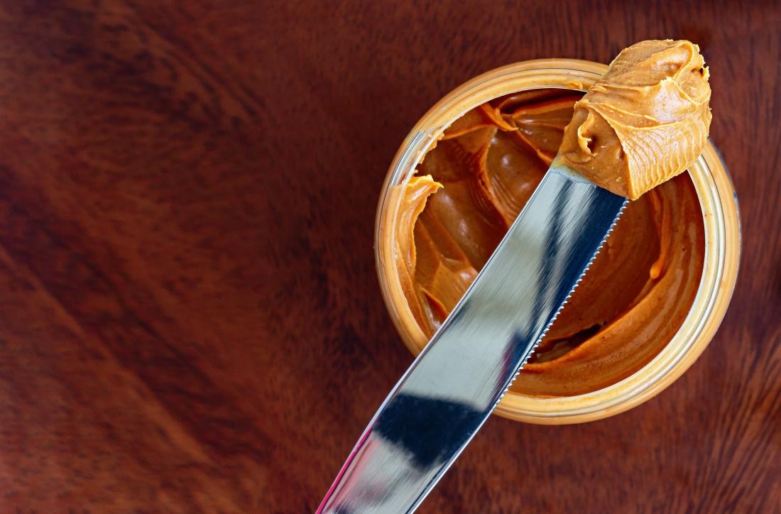 almond butter being spread on bread