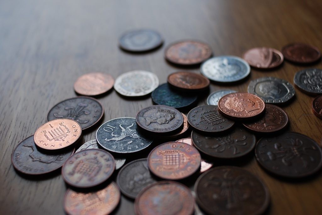 A display of old British coins including shillings.
