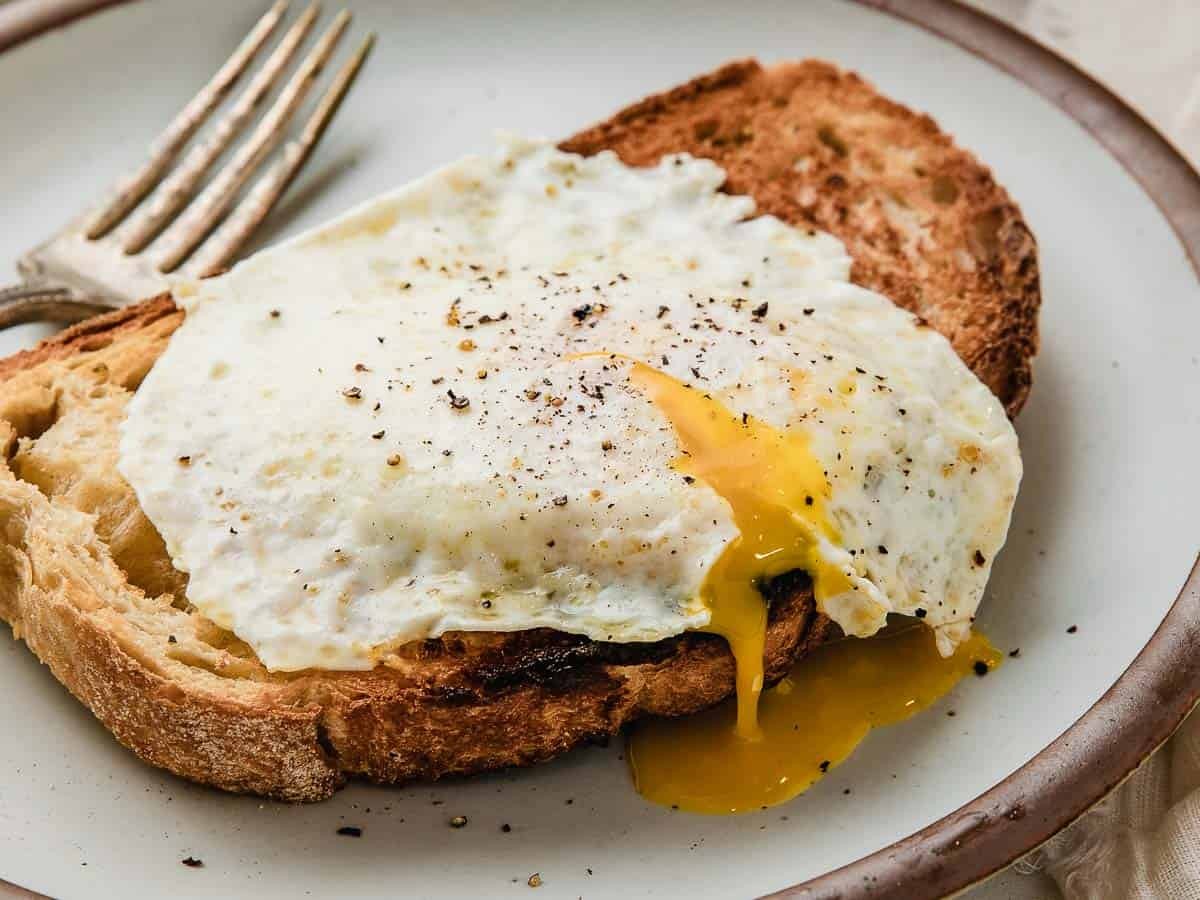 Over easy egg with a runny yolk on a plate