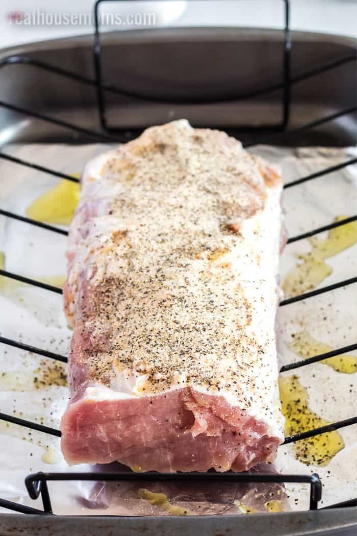 Pork loin seasoned and ready for the oven, showcasing the marbling and fat cap