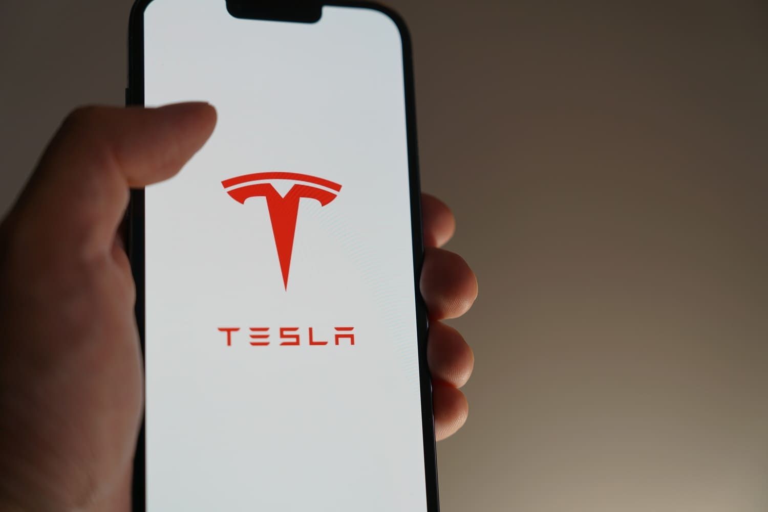 Person opening the Tesla app