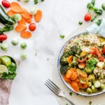Woman preparing a healthy salad with avocado and olive oil