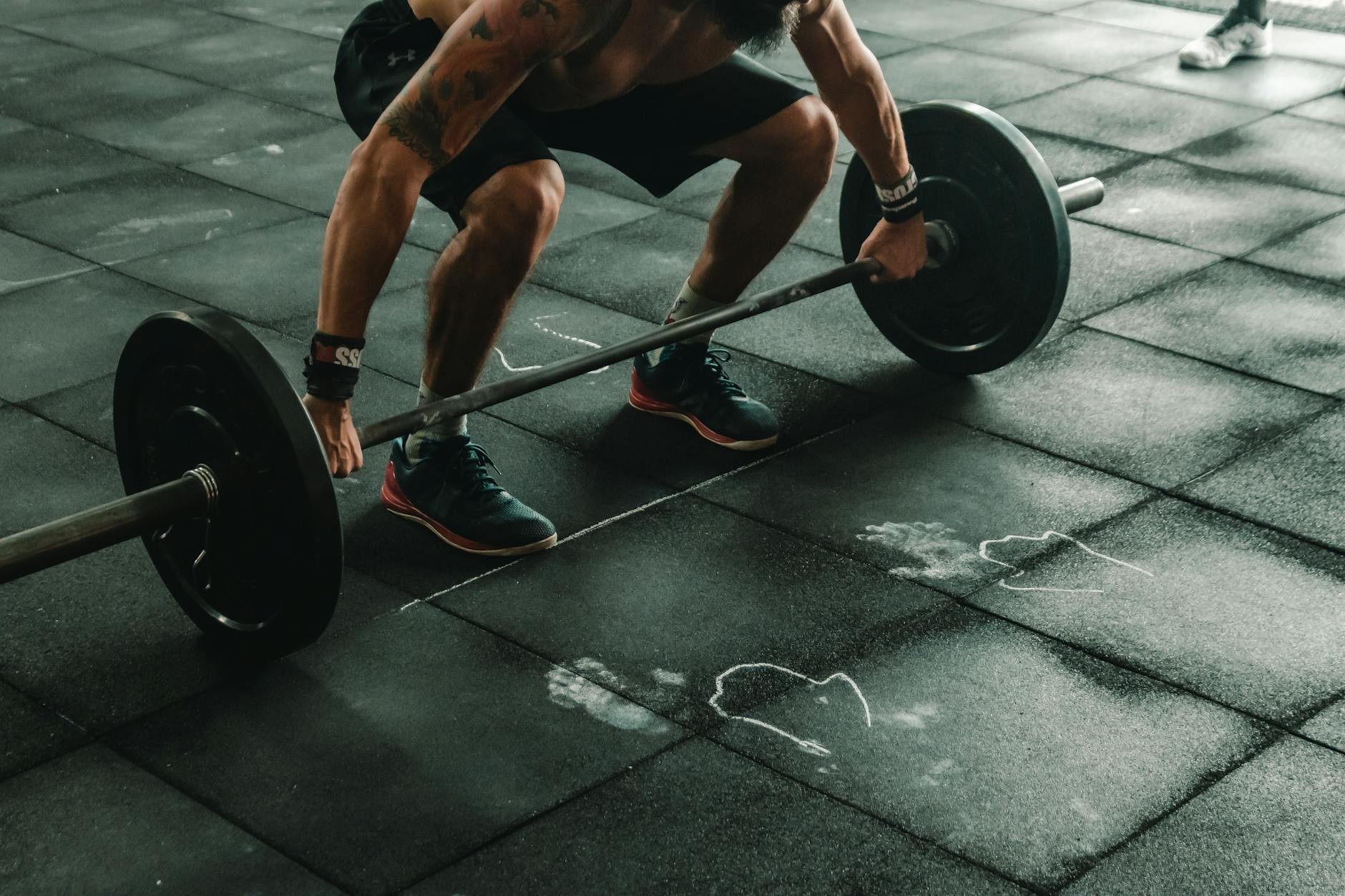 A personal trainer assisting a client at the gym