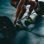 Gym goers working out with weights and machines