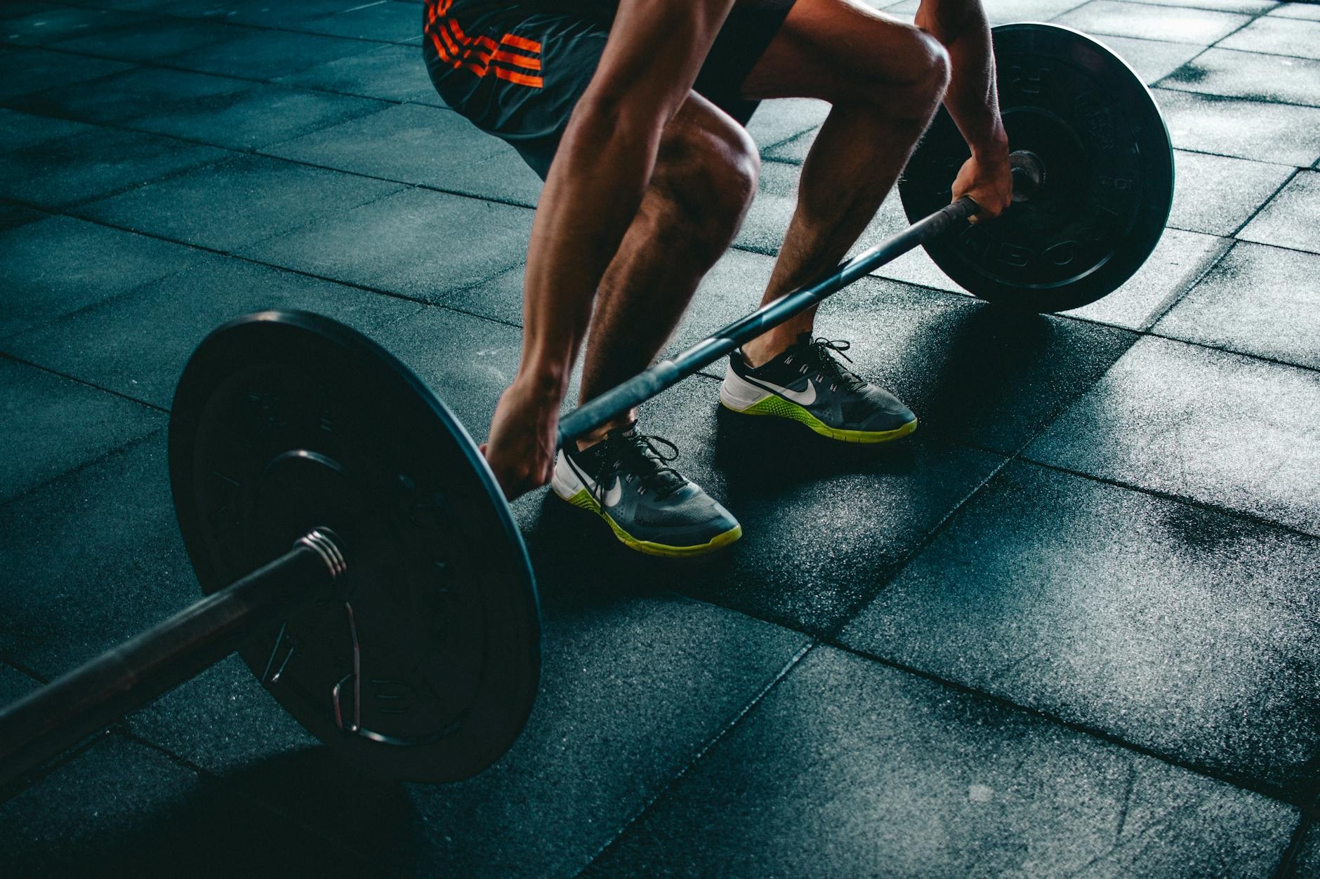 Gym goers working out with weights and machines
