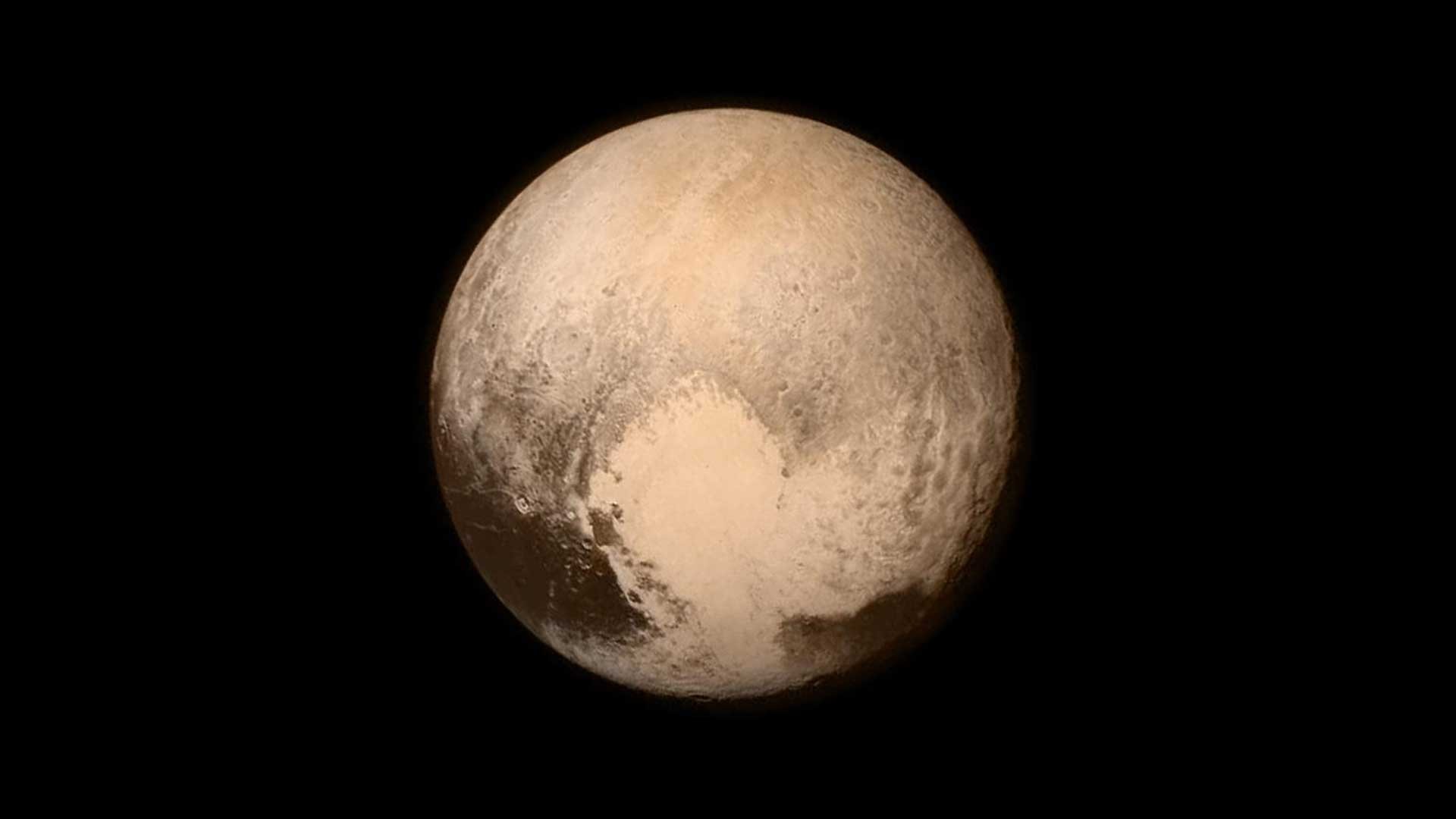 Pluto's reddish surface with the prominent heart-shaped feature, captured by the New Horizons spacecraft.