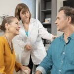 Audiologist explains the benefits of hearing aids to patient