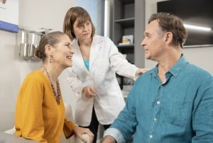 Audiologist explains the benefits of hearing aids to patient