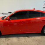 Sedan window tint cost showing a black sedan with tinted windows