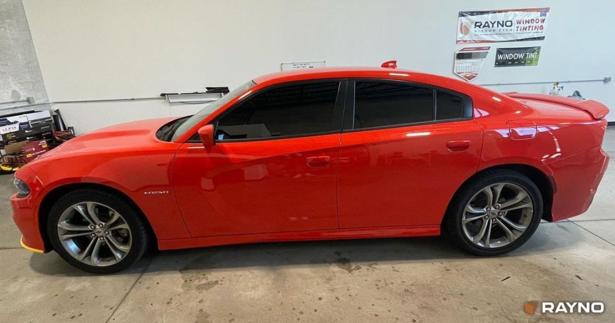 Sedan window tint cost showing a black sedan with tinted windows