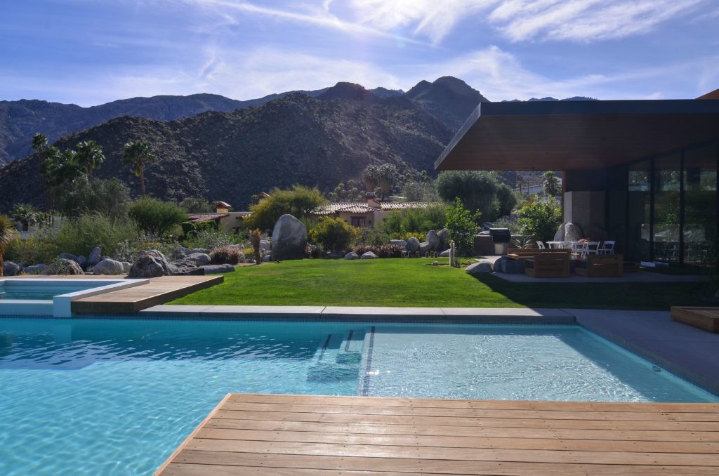A swimming pool with a breath taking mountain view and a landscape