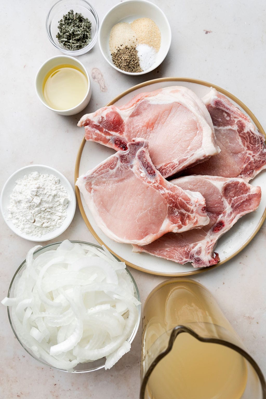 Overhead view of raw pork loin chops with seasoning