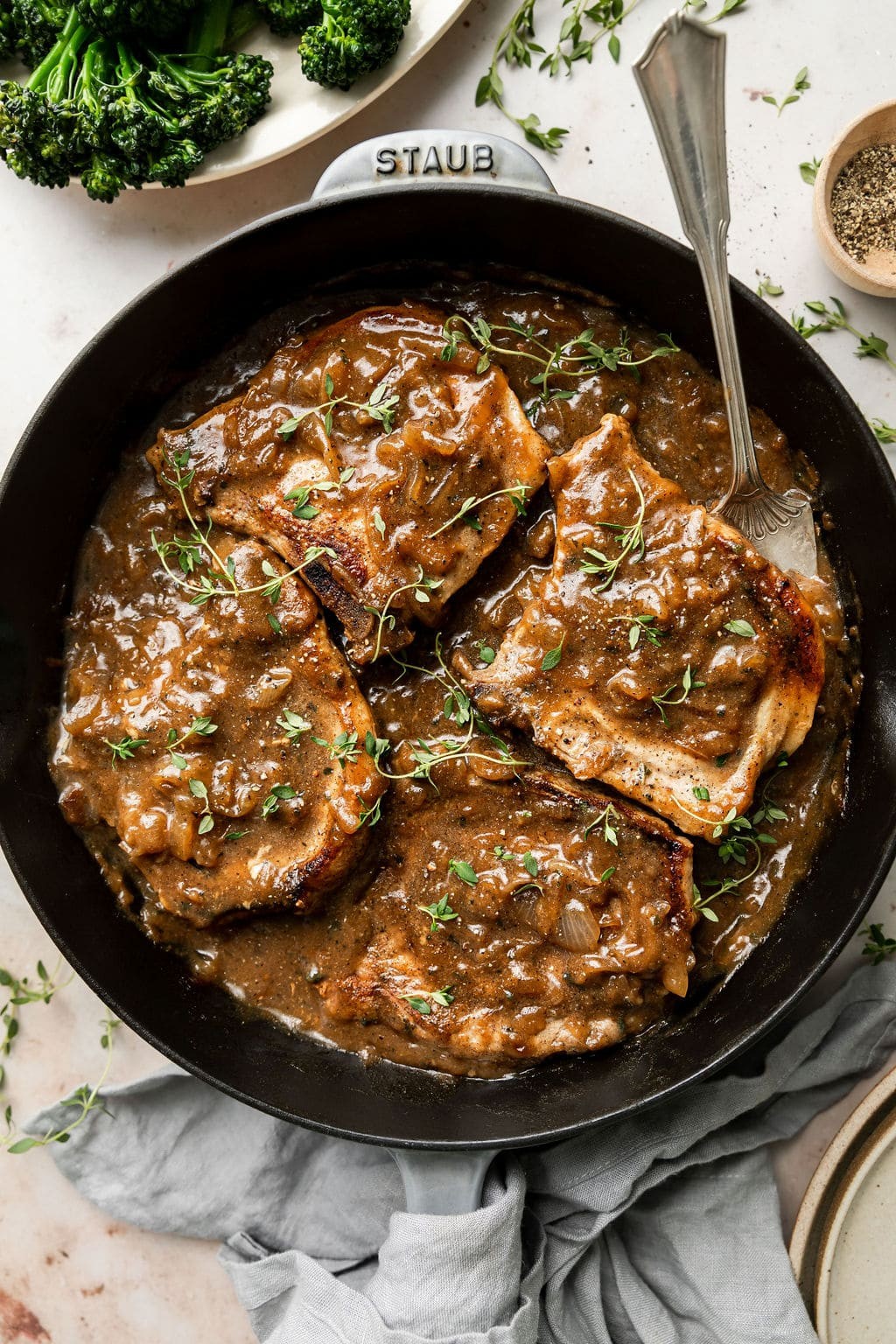 Overhead view of smothered pork chops with gravy