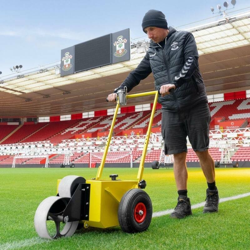 Groundsman painting lines to a soccer field