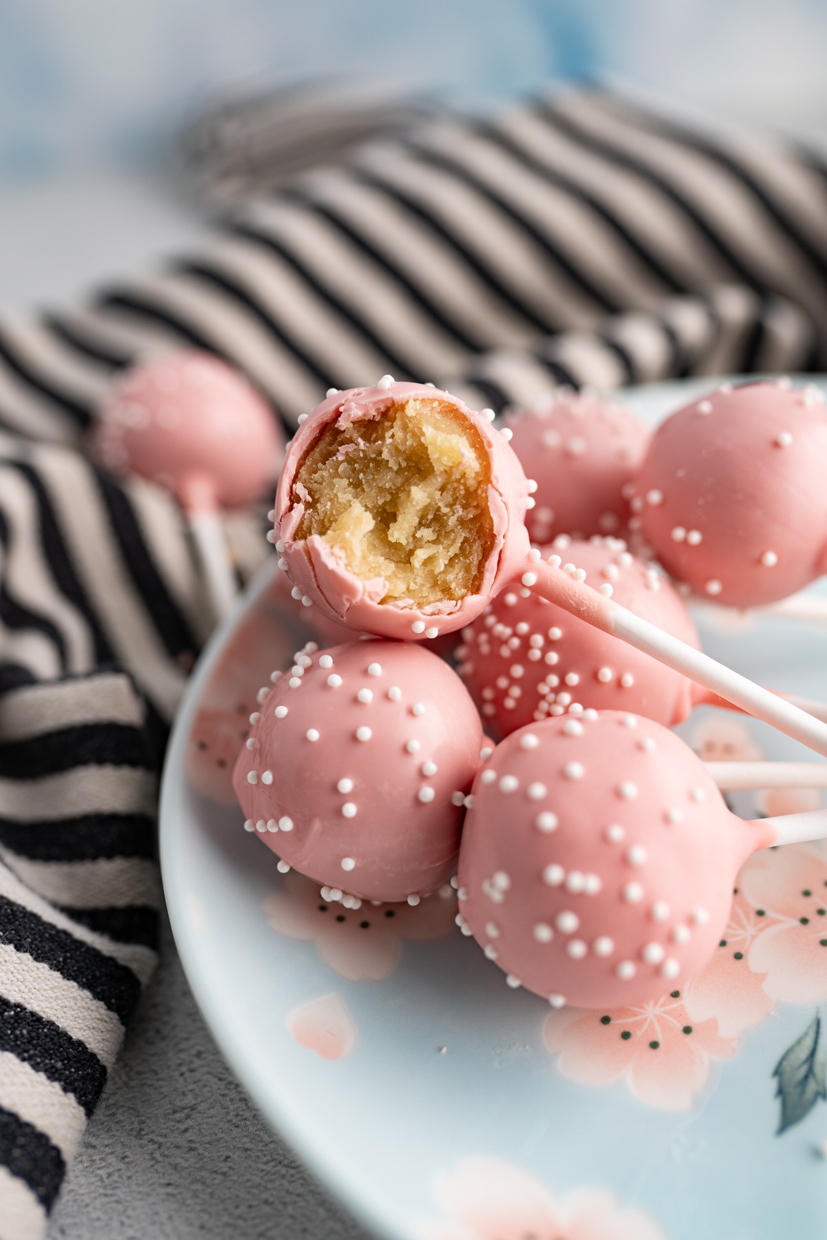 Close-up of a Starbucks birthday cake pop showing the pink coating and sprinkles.