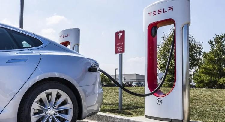 Tesla being charged at a home charging station, offering a convenient and cost-effective solution