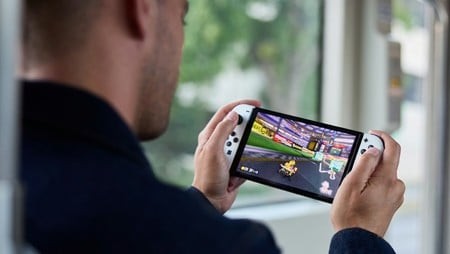 Nintendo Switch Lite close-up showing game cartridge slot, SD card slot, and power button