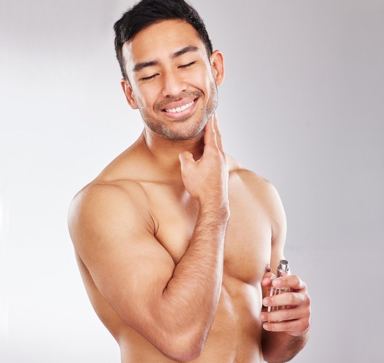 Man applying cologne on his neck