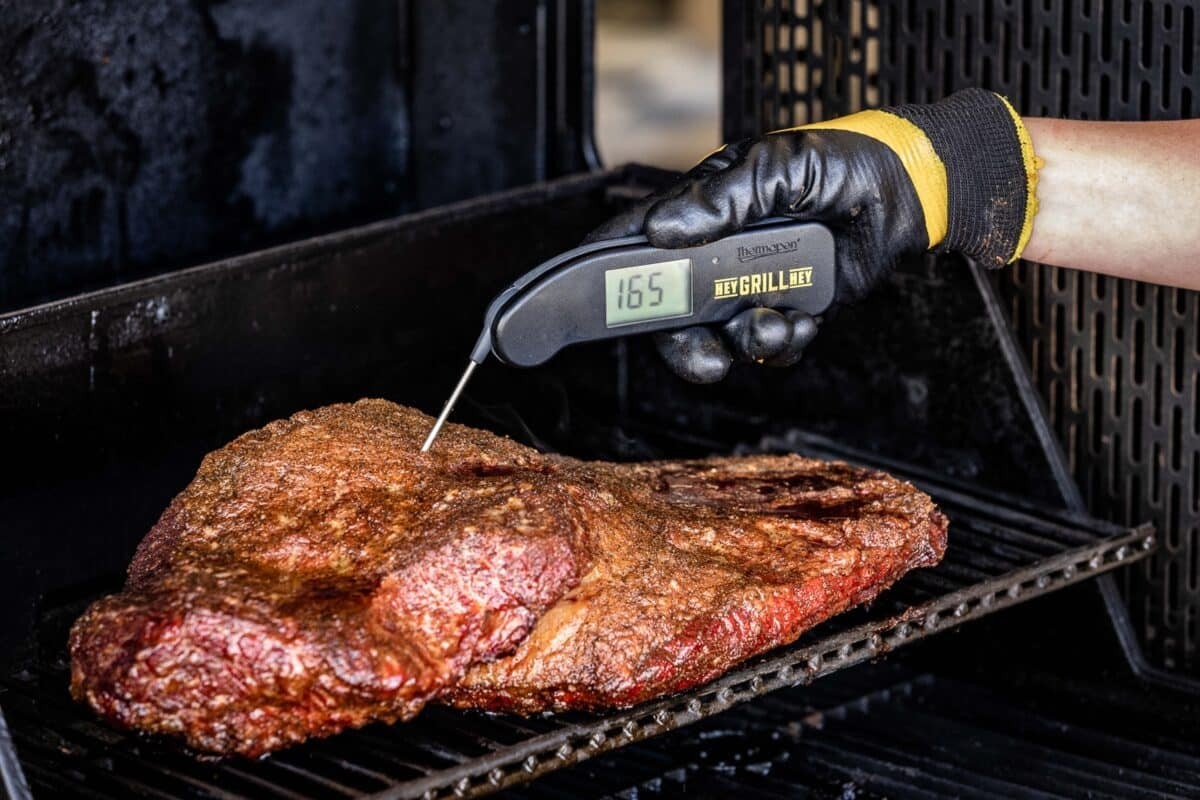 Close-up of brisket being probed with a meat thermometer