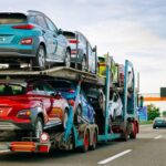 Multi-colored cars on transport trailer truck