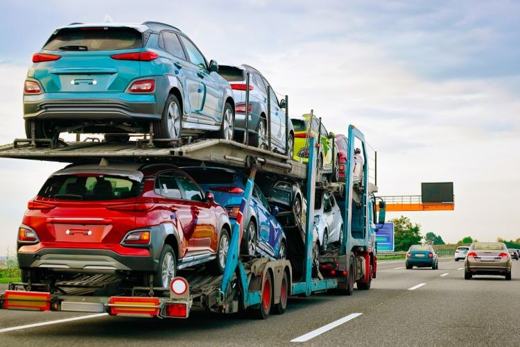 Multi-colored cars on transport trailer truck