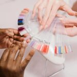 Woman showing her acrylic nails, highlighting salon services and detailed designs.